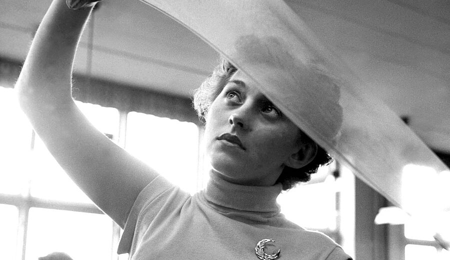 Picture of a factory worker examining nylon stockings