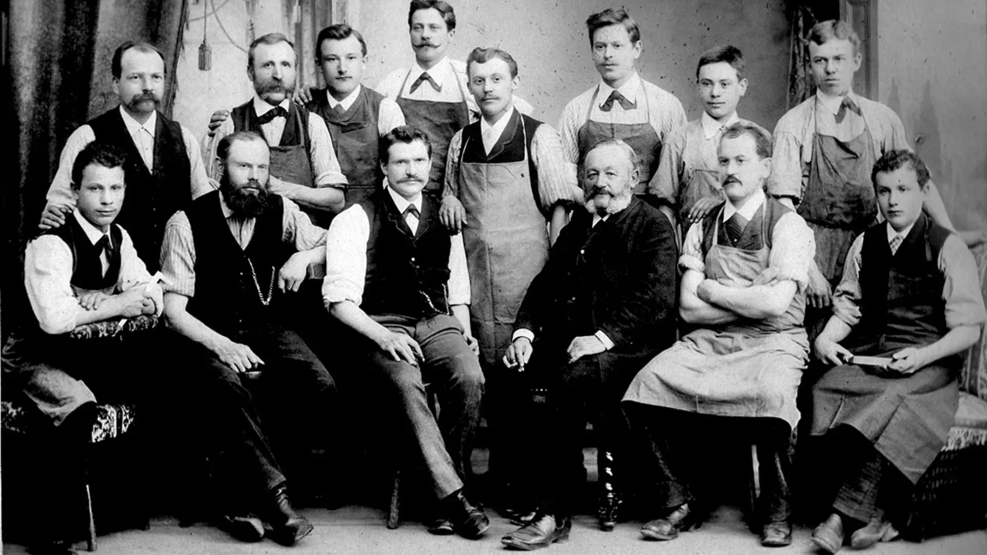 A group of men pose for a black and white photo from 1888