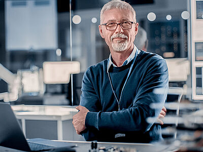 Picture of a man with his laptop at work 