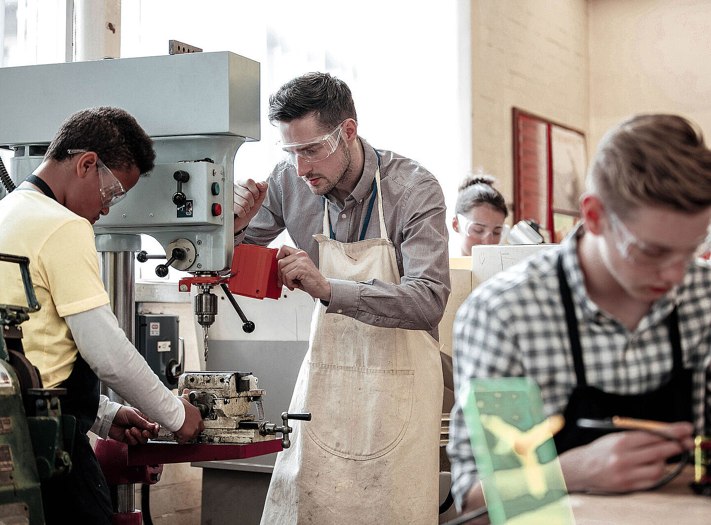 A group of people working on a machine in a workshop
