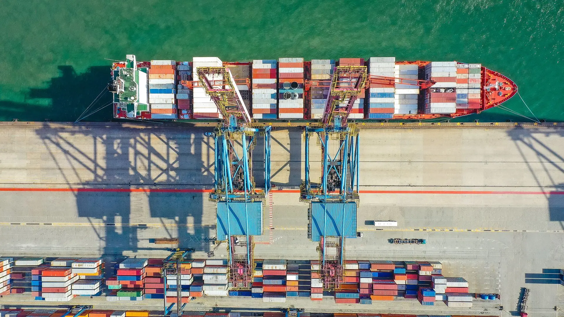 Image of a container ship being loaded from above