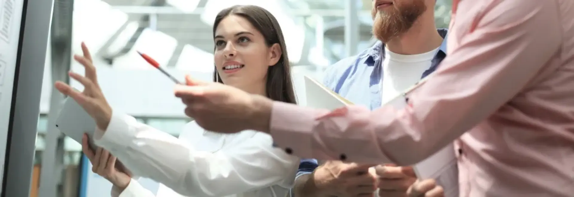 A group of people working on a whiteboard