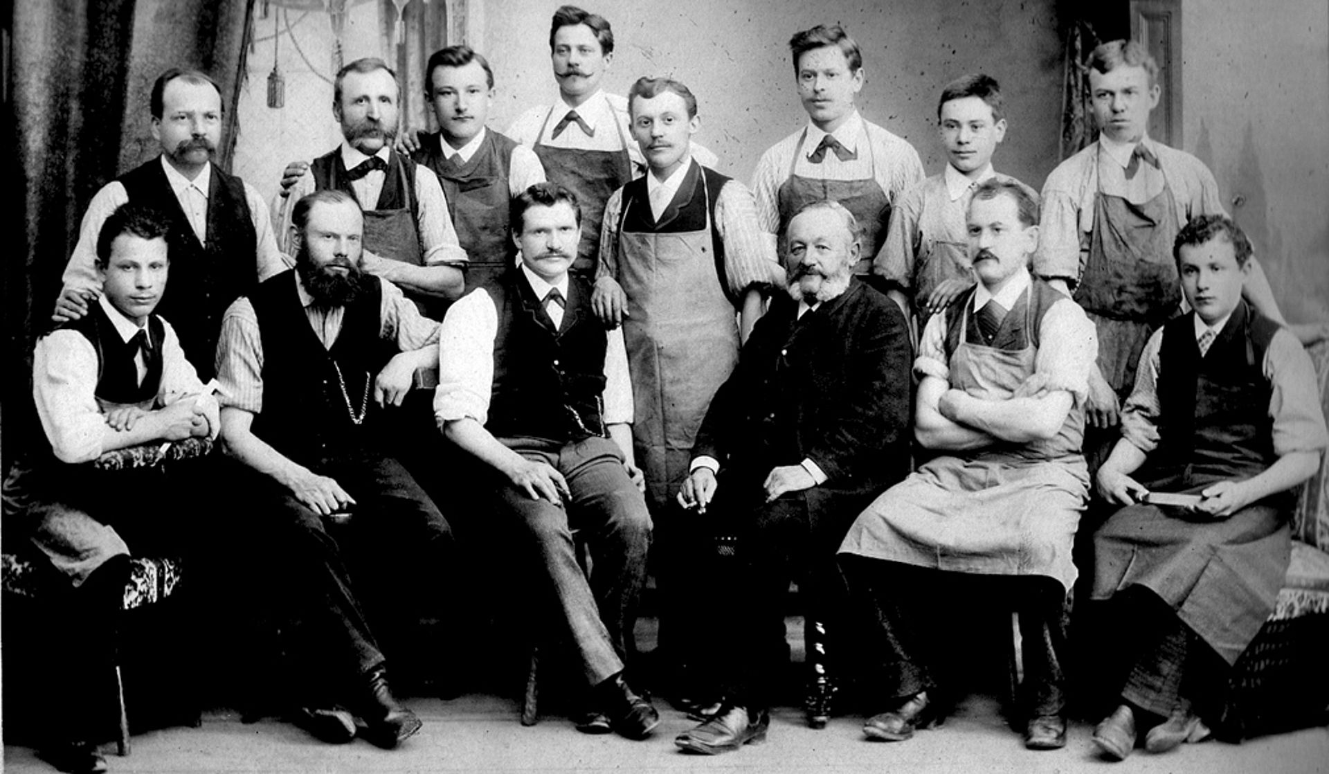 A group of men pose for a black and white photo from 1888